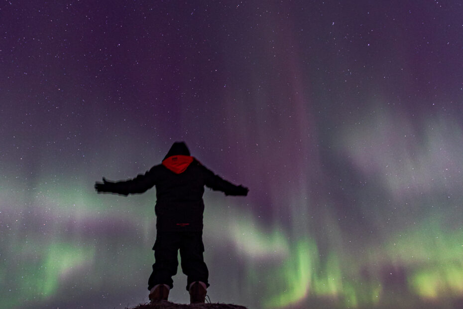 Man standing in front of aurora