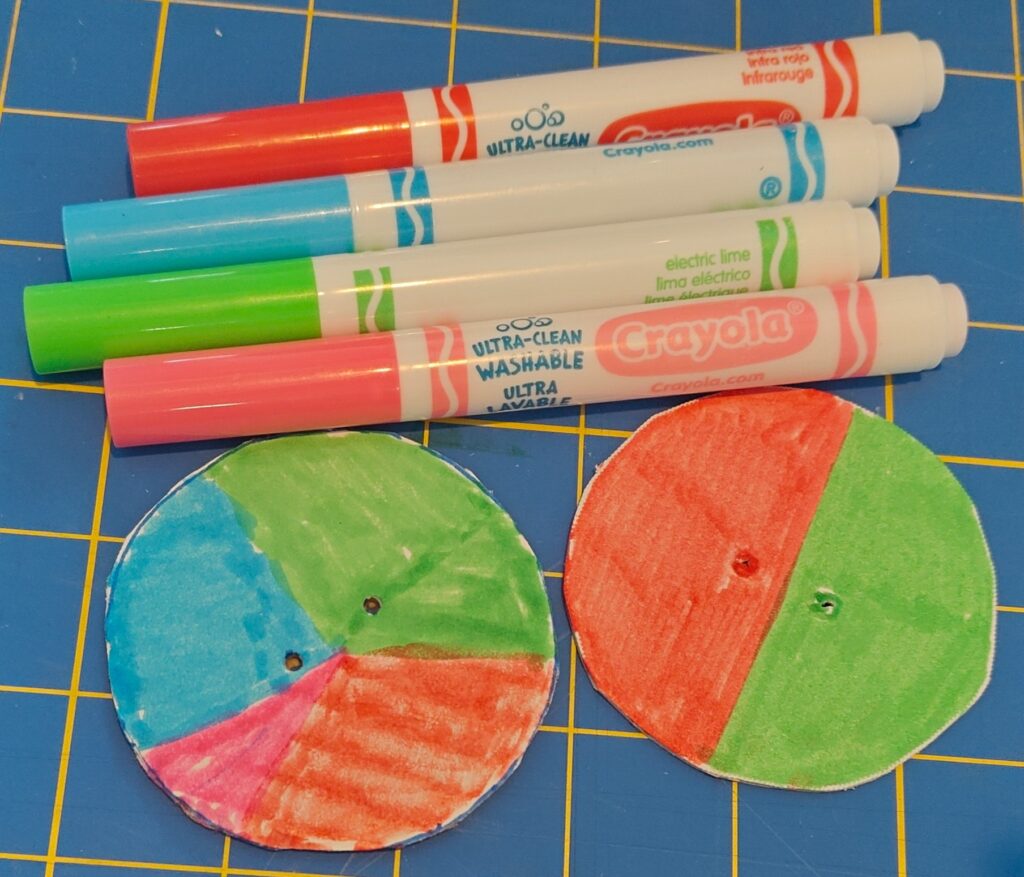 Image shows cardboard and quickboard circles with red, blue, green, and pink markers. The quickboard circle is colored in half green and half red, and the cardboard circle is colored red, green, blue, and pink.