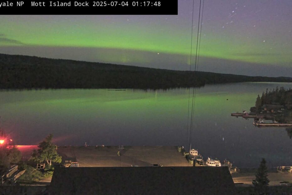 A soft green aurora over water.